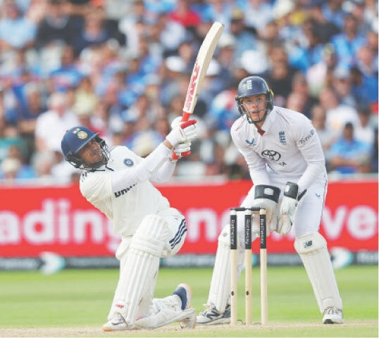  INDIAN captain Shubman Gill plays a lofted shot as England wicket-keeper Jamie Smith looks on during the second Test at Edgbaston on Saturday.—Reuters 