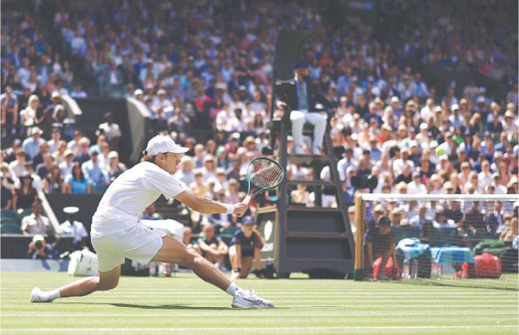  AUSTRALIA’S Alex de Minaur in action during his Wimbledon round-of-16 match against Novak Djokovic of Serbia at the All England Lawn Tennis and Croquet Club on Monday.—Reuters 