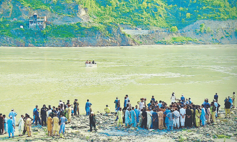 Rescuers search for body of a boy swept away by the Indus River in Torghar on Tuesday. — Dawn