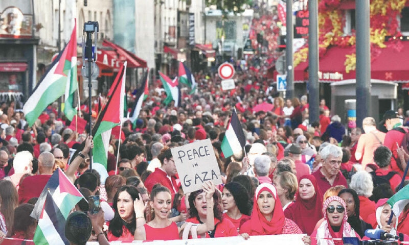 PARIS: Protesters take part in the ‘human red line’ demonstration, organised at the Place de la Republique by non-governmental organisations including Amnesty International, to call for a ceasefire in Gaza.—AFP