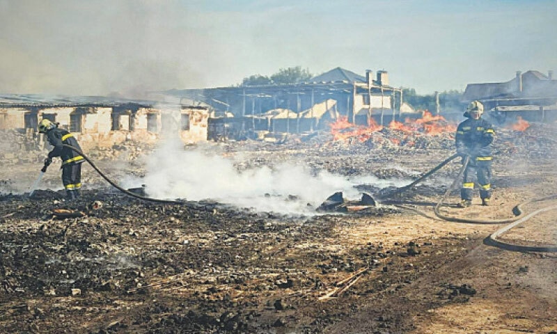 FIREFIGHTERS try to douse a blaze after a Russian attack near Kyiv.—AFP