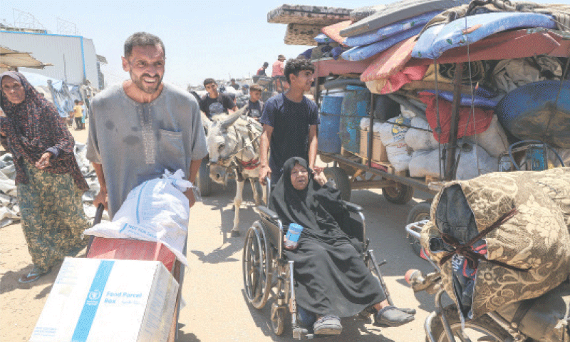 Displaced Palestinians make their way towards Mawasi area as they flee amid an Israeli ground offensive in Khan Yunis, southern Gaza Strip, on Thursday.—Reuters