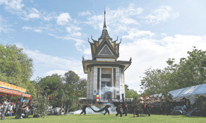 STUDENTS re-enact Khmer Rouge crimes to mark an annual ‘Day of Remembrance’ at the Choeung Ek memorial in Phnom Penh. The memorial is among three 
Cambodian torture sites added to Unesco’s heritage list on Friday.—AFP