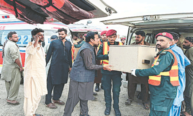 RESCUE personnel transfer the body of a passenger into an ambulance in Zhob district of Balochistan, a day after he was slain in a terrorist attack.—AFP