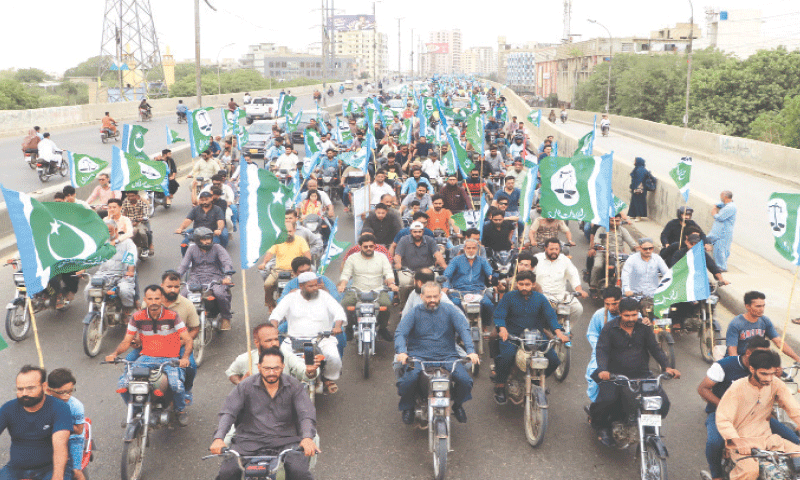 Participants of a ‘bike rally’, organised by the Jamaat-i-Islami, pass through the Liaqutabad flyover.
—Shakil Adil / White Star