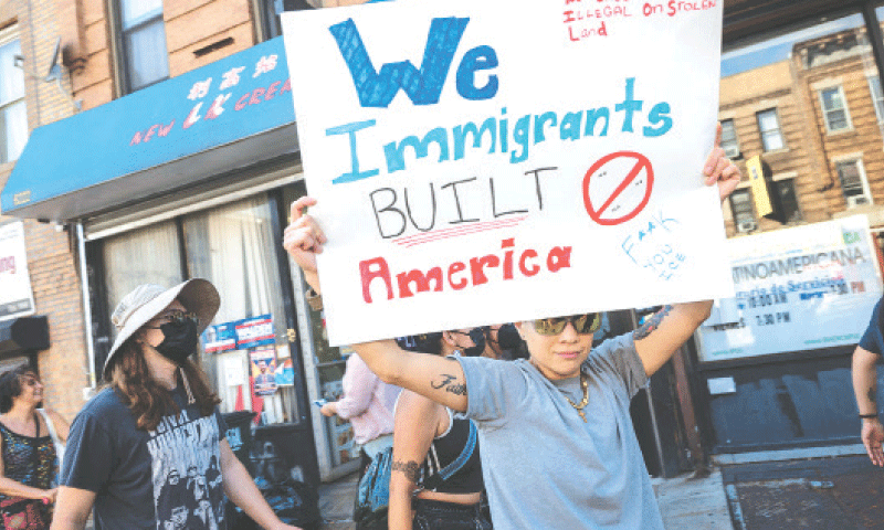 AN activist holds a poster during a demonstration and march against a new immigrant detention centre in Brooklyn, New York City.&mdash;AFP