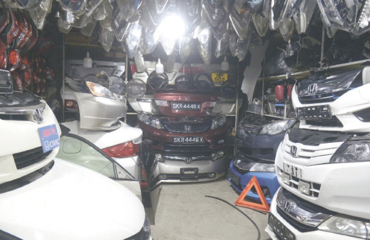 Car Bumpers are on s ale at a auto spare parts shop.