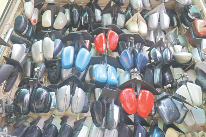 Second-hand side mirrors of vehicles of all models are displayed at a shop.