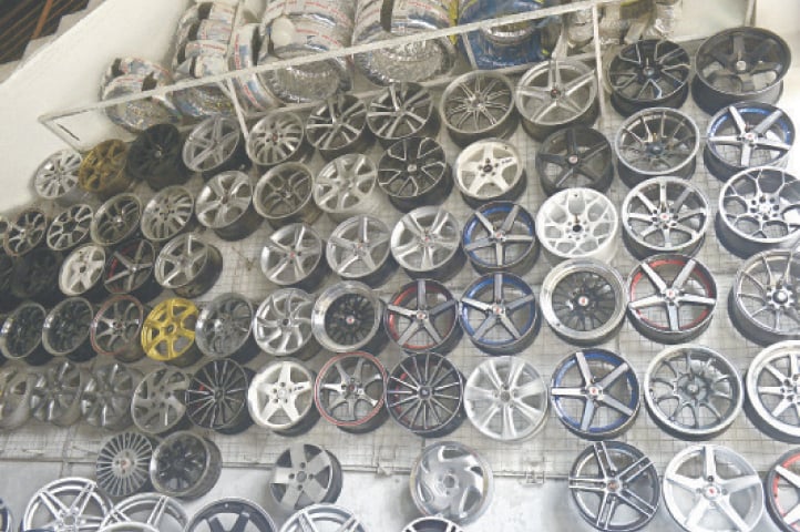 Wheel rims are displayed at a shop.