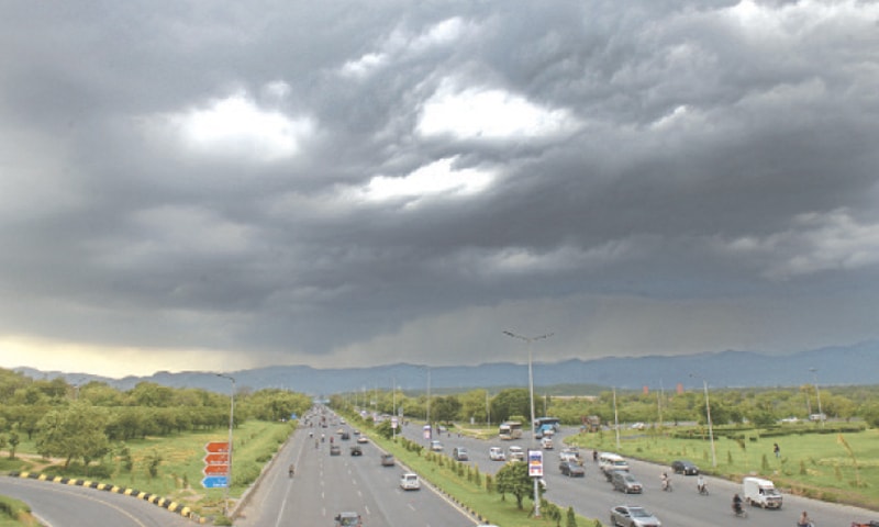 Dark clouds hang over Islamabad before rain lashed the city on Sunday. — Photo by Mohammad Asim
