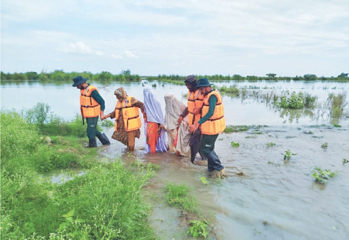  MIANWALI: Rescue 1122 personnel evacuate villagers from flooded-hit area of Cheenapura in Isakhel tehsil. More than 120 people along with their belongings and 135 domestic animals were moved to higher grounds on Sunday night. — Dawn 
