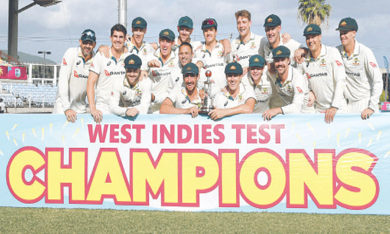 AUSTRALIAN players pose with the Test series trophy after defeating West Indies in the third match at the Sabina Park.&mdash;AFP