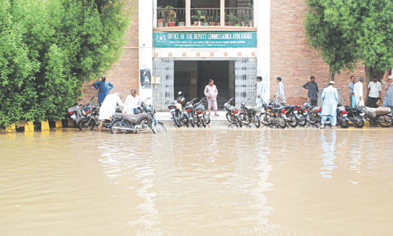 RAINWATER remained accumulated till Tuesday evening in front of the Shahbaz Building, which houses most offices of the Hyderabad district administration—Dawn