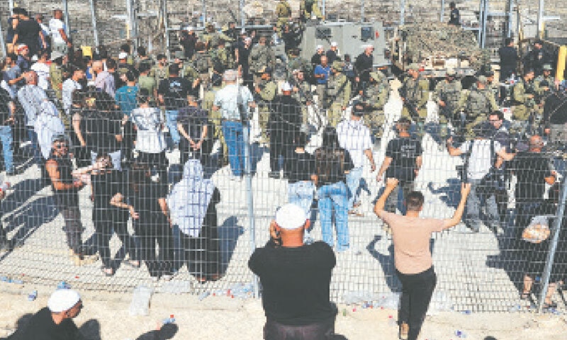 Majdal Shams: Members of the Israeli Druze community gather near the ceasefire line between the Israeli-occupied Golan Heights and Syria.—Reuters