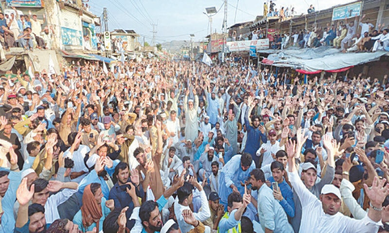Residents participate in a peace march in Mian Mandi Bazaar of Halimzai tehsil, Mohmand, on Friday. — Dawn
