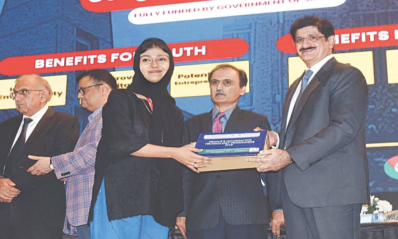 CM Murad Ali Shah presents a Chromebook to a student at NED University.&mdash;PPI