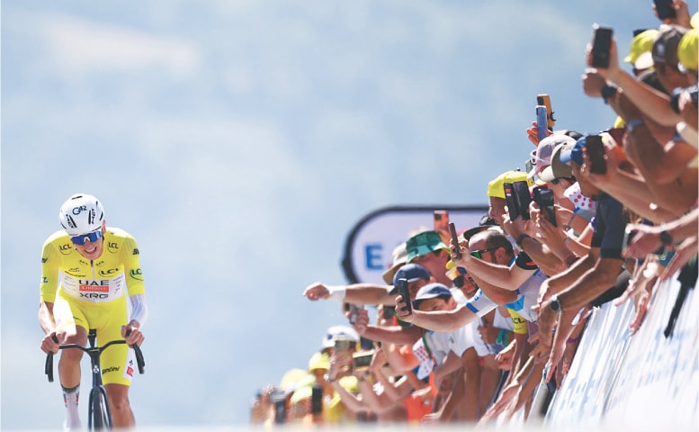 UAE Team Emirates XRG’s Tadej Pogacar of Slovenia competes on his way to crossing the finish line to win the 13th stage of the Tour de France on Friday.—AFP UAE Team Emirates XRG’s Tadej Pogacar of Slovenia competes on his way to crossing the finish line to win the 13th stage of the Tour de France on Friday.—AFP