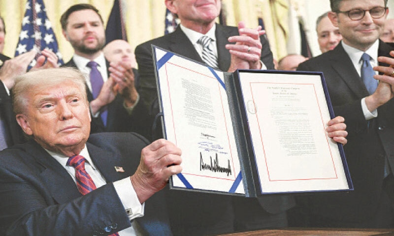 President Trump displays the GENIUS Act after signing it in the White House in Washington.—AFP