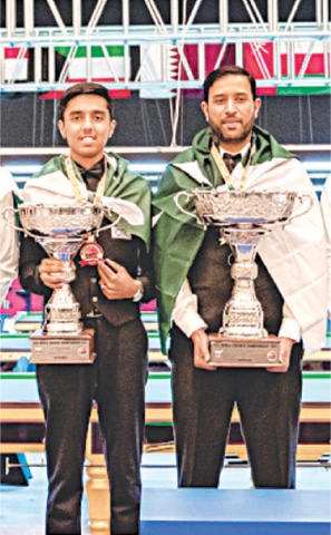  Pakistan’s Mohammad Asif (R) and Mohammad Hasnain pose with their trophies after winning the Masters and Under-17 titles respectively at the IBSF World Snooker Championship on Friday.—courtesy IBSF  