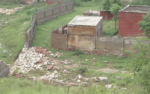 A portion of a boundary wall which collapsed due to the raging torrent.