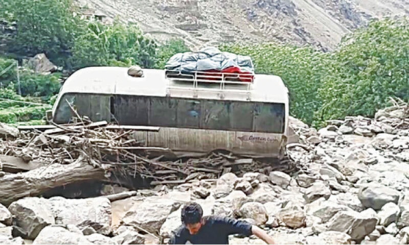 A passenger coach en route to Gilgit-Baltistan from Naran is seen after it was hit by a landslide near Babusar Top, located between Khyber Pakhtunkhwa and GB.—Photo by Nisar Ahmed Khan A passenger coach en route to Gilgit-Baltistan from Naran is seen after it was hit by a landslide near Babusar Top, located between Khyber Pakhtunkhwa and GB.—Photo by Nisar Ahmed Khan