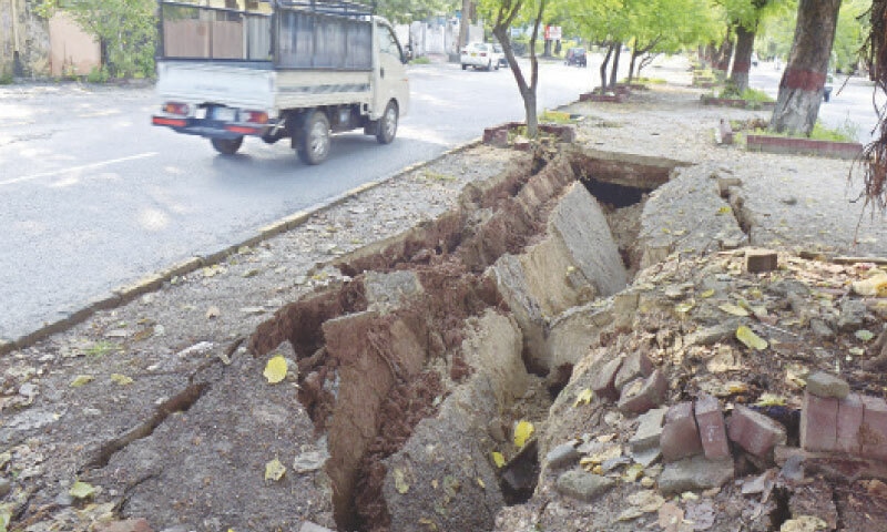 A Median in front of G-6 weekly bazaar in Islamabad caved in after a recent spell of torrential rain. &mdash; Photo by Mohammad Asim