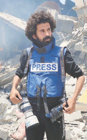  JOURNALIST Omar Al-Qattaa poses for a picture in the Gaza Strip.—AFP 