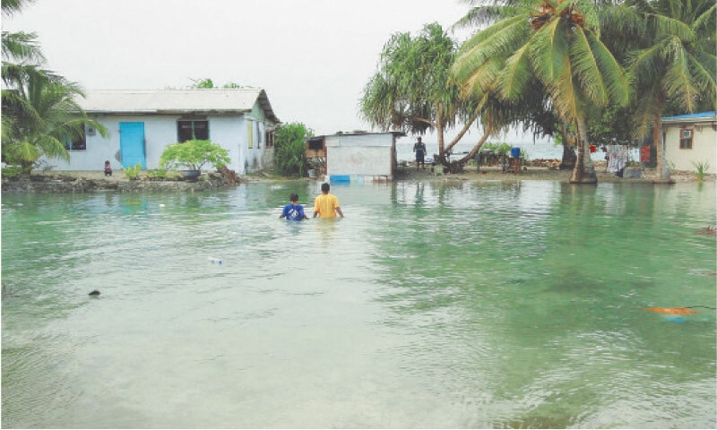 Residents wade through flooding caused by high ocean tides in low-lying parts of Majuro Atoll, the capital of the Marshall Islands.&mdash;AFP/file