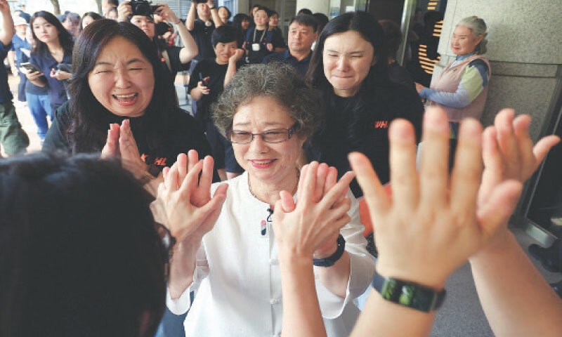 CHOI Mal-ja (centre), who was convicted 61 years ago for biting off the tongue of her attempted rapist, attends her retrial hearing at a court in Busan on Wednesday.—AFP CHOI Mal-ja (centre), who was convicted 61 years ago for biting off the tongue of her attempted rapist, attends her retrial hearing at a court in Busan on Wednesday.—AFP