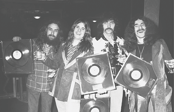 Black Sabbath pose for a group portrait with gold discs, London, 1973, L-R Bill Ward, Ozzy Osbourne, Tony Iommi, Geezer Butler | Michael Putland