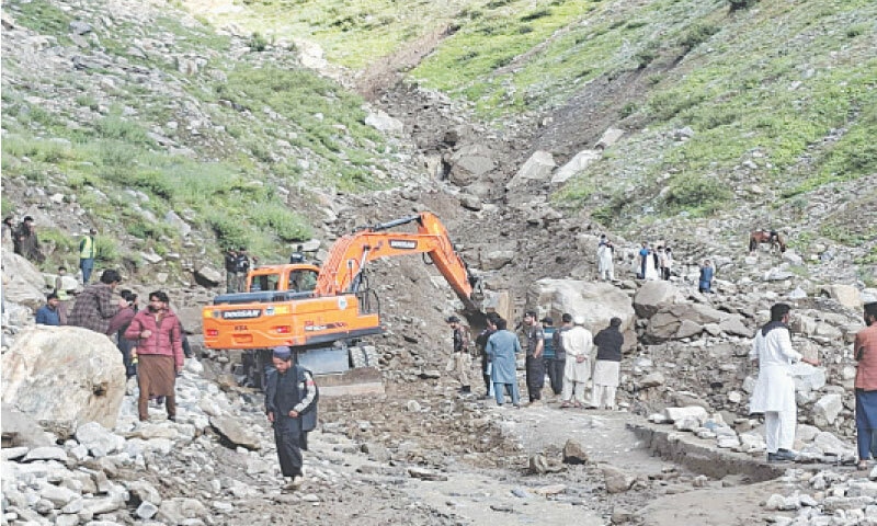 An excavator removes the rubble after a landslide blocked Saiful Muluk Road near Naran on Friday. — Dawn