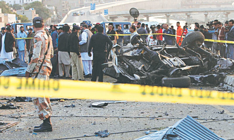  Police cordon off the area following the bombing that killed Chaudhry Aslam in Karachi on January 9, 2014: Aslam, who had survived numerous assassination attempts in the past, died when a suicide bomber smashed his vehicle into Aslam&rsquo;s convoy on the Lyari Expressway in Karachi | AP 
