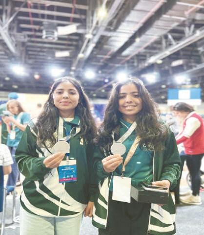 The two sisters pose with their medals. — Dawn