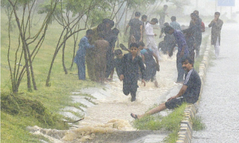 Youngsters enjoy rainy weather in Islamabad. File photo