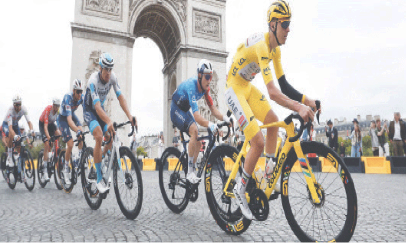 UAE Team Emirates XRG’s Slovenian rider Tadej Pogacar in action with riders as they pass the Arc de Triomphe during the 21st stage of the Tour de France on Sunday.—Reuters