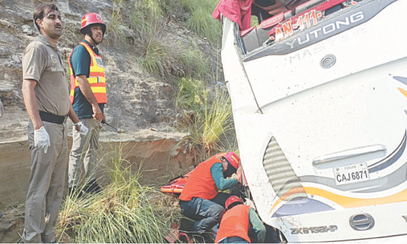 Motor&shy;way Police and Rescue 1122 personnel inspect the ill-fated bus after the mishap.&mdash;Dawn