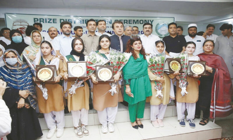 Provincial minister for education Faisal Khan Tarakai in a group photo with the position holders in SSC exam results of Peshawar board on Monday. &mdash; White Star