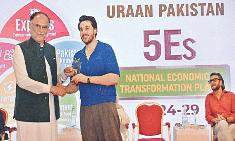 PLANNING Minister Ahsan Iqbal distributes souvenirs among the panellists of the dialogue.—APP