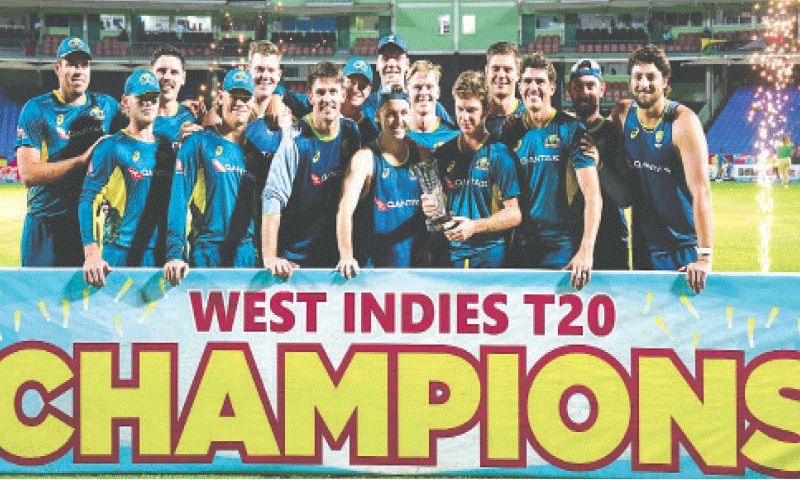 AUSTRALIAN players celebrate with the T20 series trophy after defeating West Indies in the fifth match at the Warner Park Sporting Complex.—AFP