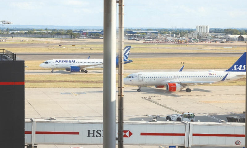 A PLANE prepares to take off from London’s Heathrow Airport after a radar failure led to the suspension of outbound flights across Britain.—Reuters