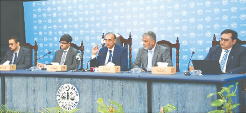 KARACHI: State Bank Governor Jameel Ahmed addresses the media following the announcement of the monetary policy.—Dawn