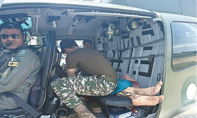 A man injured in the mortar shell blast being airlifted to Peshawar on Thursday. &mdash; Dawn