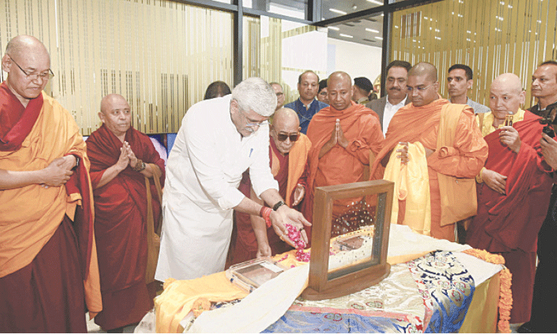 INDIA’s Minister of Culture and Tourism Gajendra Singh Shekhawat prays after he received the repatriated relics at the airport in New Delhi.—Reuters