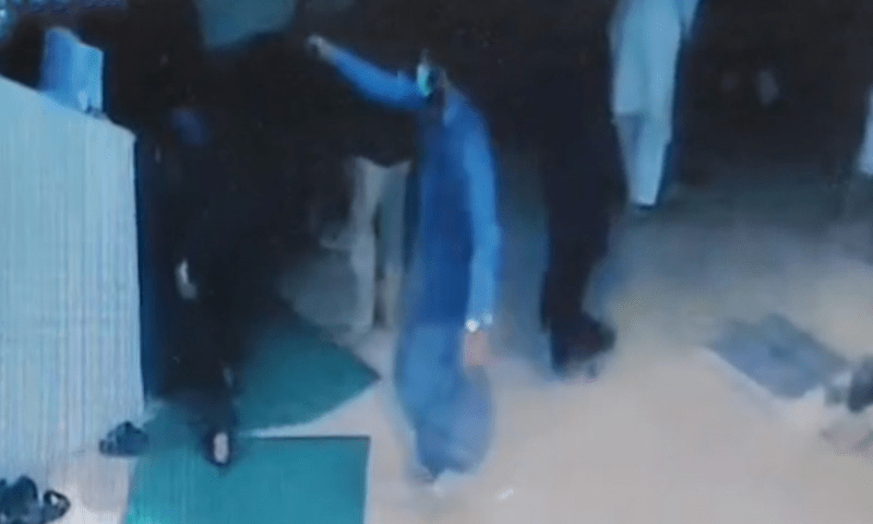 An attacker draws a pistol at lawyer Khawaja Shamsul Islam and his son outside a mosque in Karachi on August 1. — DawnNewsTV