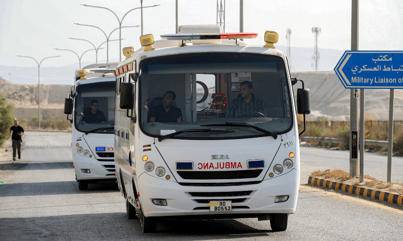 Ambulances arriving carrying people from the Gaza Strip at the King Hussein Bridge border crossing in western Jordan, July 30. — AFP