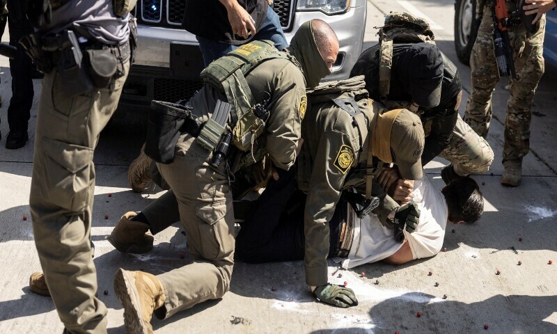 A man is detained as clashes break out after US Customs and Border Protection (CBP) officers attempted to raid a store in Bell, just south of Los Angeles, California, on June 20. &mdash; AFP