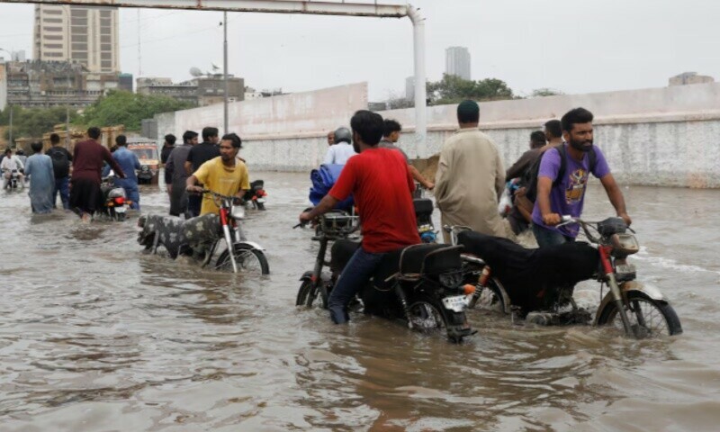 Residents commute through a flooded road during the monsoon season in Karachi, Pakistan July 9, 2022.  &mdash; Reuters/ Akhtar Soomro