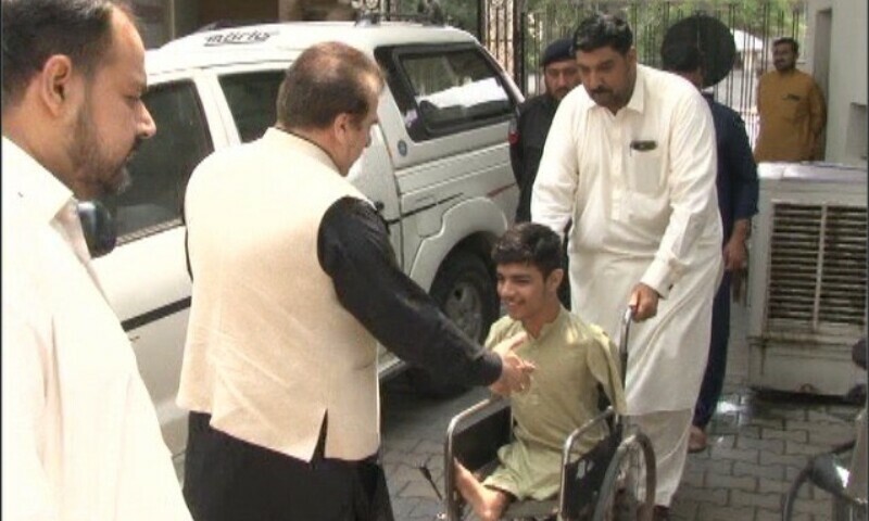  Peshawar Division Commissioner Riaz Mehsood greets Sudais Khan in Peshawar, Aug 2. — DawnNewsTV 