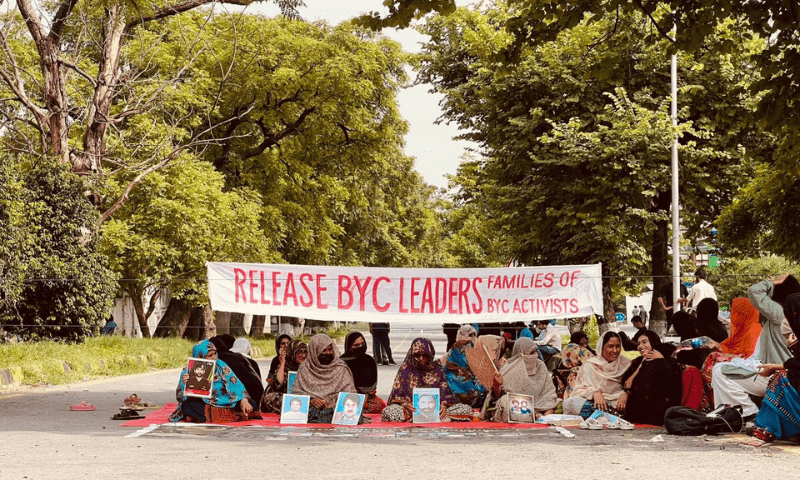 Protestors sit on a road near the National Press Club on Monday demanding the release of detained BYC leaders. &mdash; Photo via X/@BalochYakjehtiC
