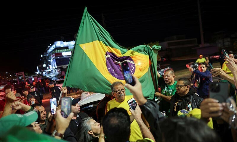 Supporters of former Brazilian President Jair Bolsonaro gather outside the residential development where the former Brazilian President lives, after Brazil&rsquo;s Supreme Court issued a house arrest order for him, in Brasilia, Brazil, August 4, 2025. &mdash; Reuters